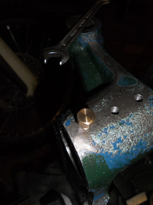 Brass screws were added as a temporary fix to deal with the play on the shaft.